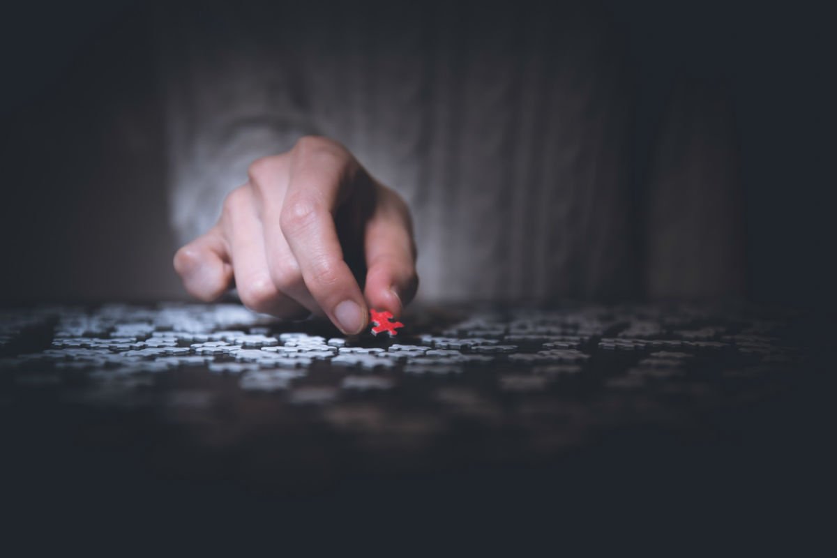 Man holding red puzzle piece