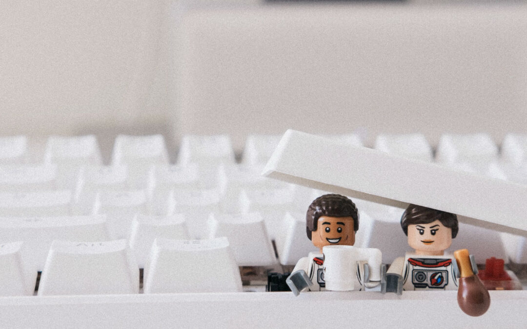two lego figures underneath the space bar on the keyboard